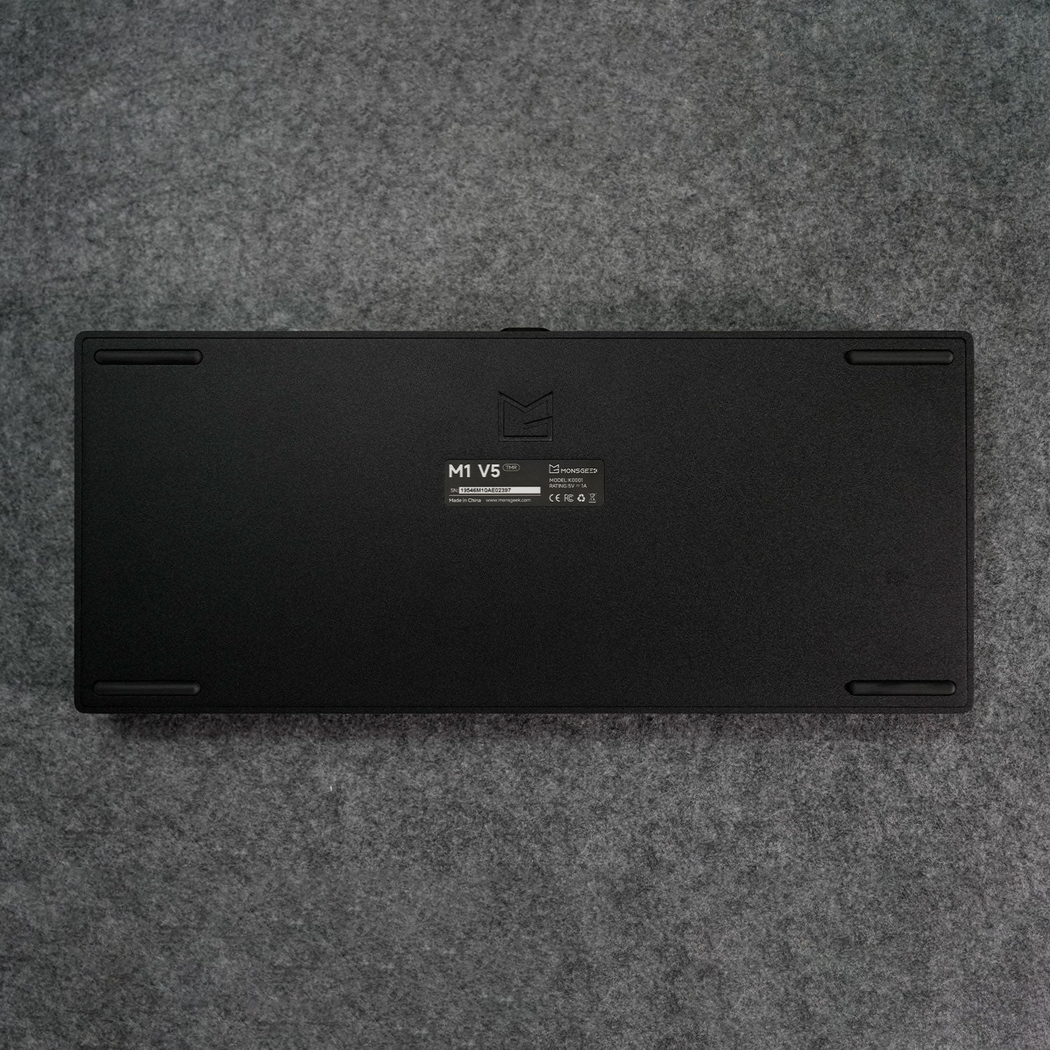 Black MonsGeek M1 V5 HE Magnetic Keyboard Back Details on a gray textured surface