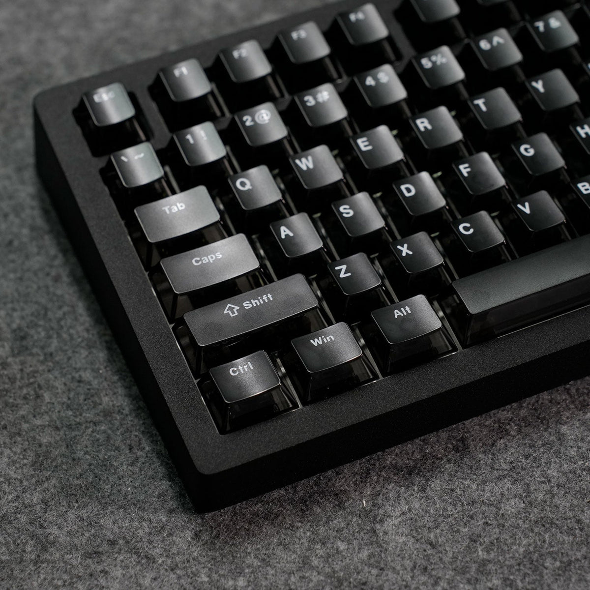 Close-up of a MonsGeek M1 V5 HE Magnetic Keyboard on a textured surface
