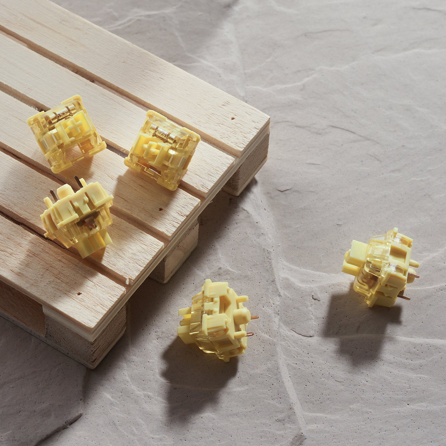 A collection of V3 Cream Yellow Pro Switches on the wooden desk