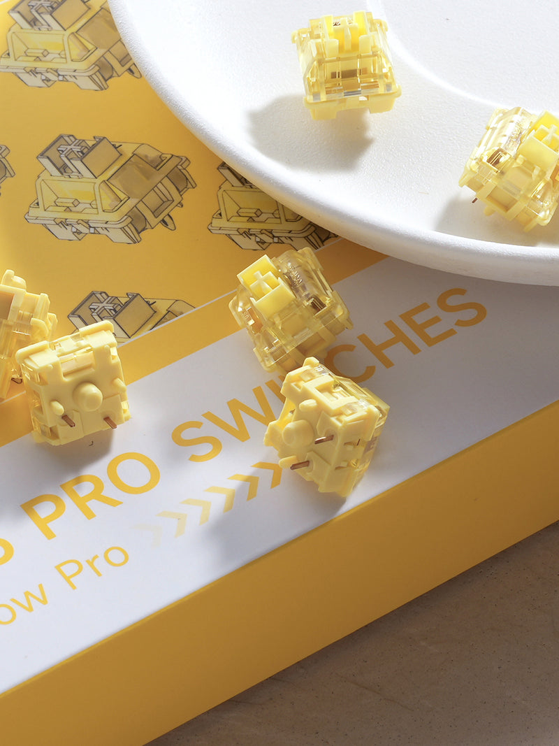 A collection of V3 Cream Yellow Pro Switches on the desk