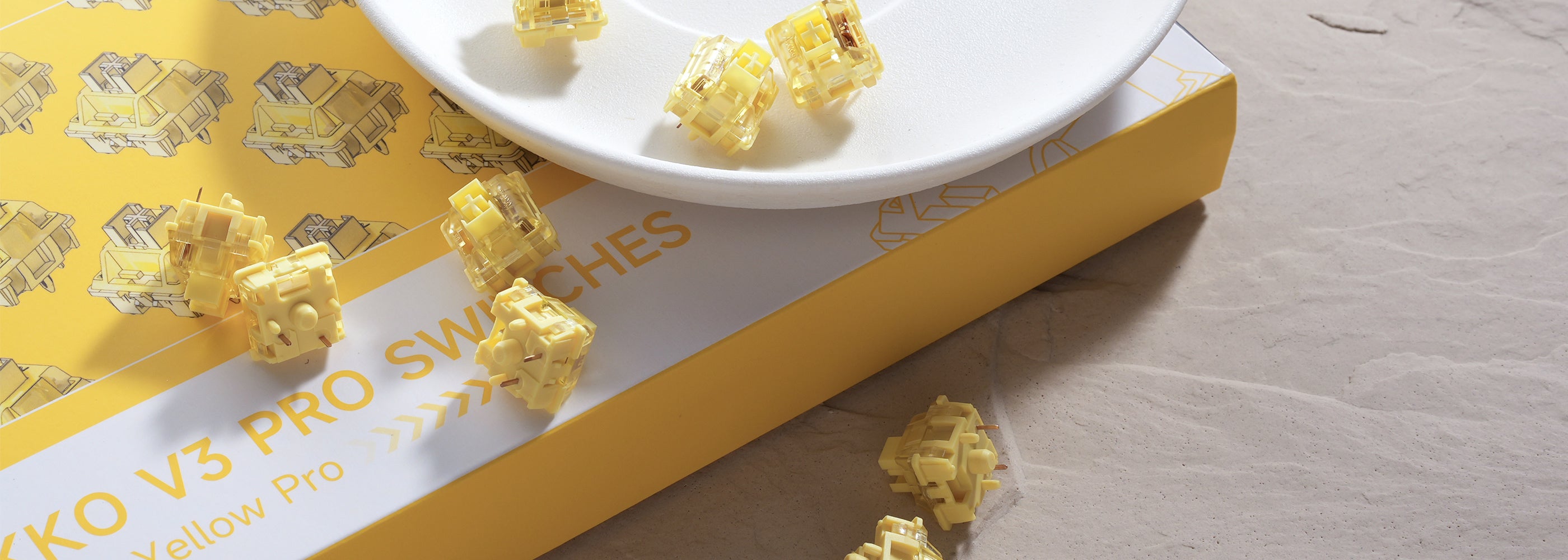 A collection of V3 Cream Yellow Pro Switches on the desk